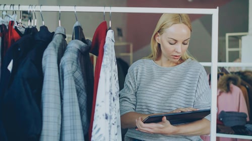 Retail store manager reviewing inventory on a tablet — signs your retail stack may be holding back growth