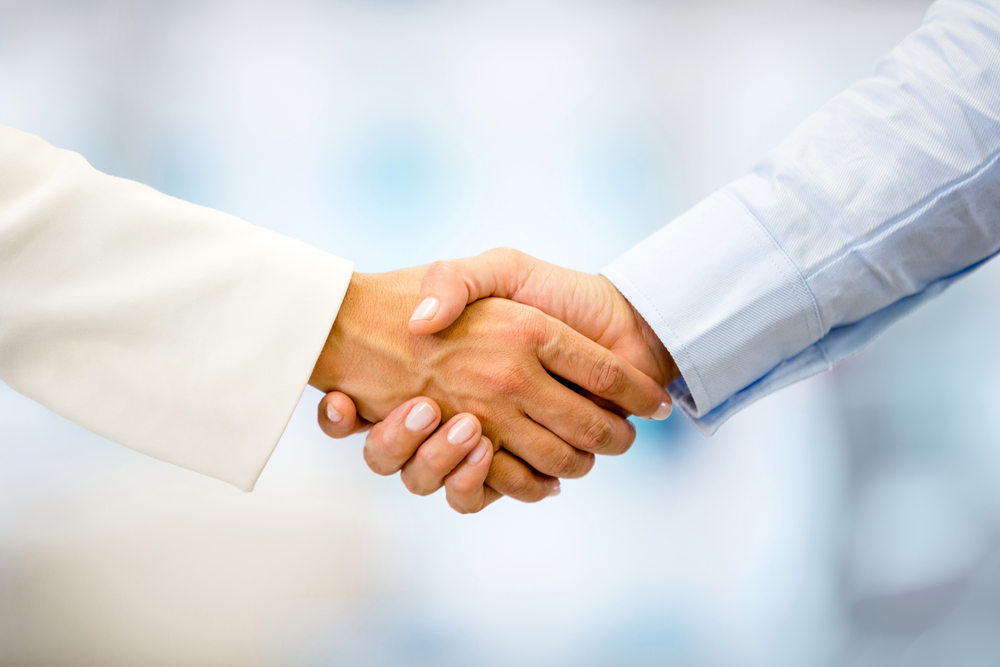 Business leaders shaking hands after agreeing terms with a Business Central implementation partner